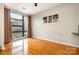 Living room featuring hardwood floors, neutral decor, and a large window offering natural light at 525 E Sixth St # 208, Charlotte, NC 28202