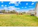 Full view of the backyard with playground, storage shed, patio, and fire pit at 5405 Austin Rd, Monroe, NC 28112