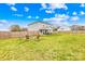View of the backyard with the covered back patio and firepit at 5405 Austin Rd, Monroe, NC 28112