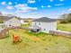 Expansive backyard featuring a fenced perimeter, playset, fire pit, and covered patio at 5405 Austin Rd, Monroe, NC 28112