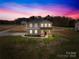 Stunning two-story home featuring a gray exterior, a welcoming porch, and a spacious front yard at 5405 Austin Rd, Monroe, NC 28112