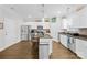 Well-lit kitchen features white cabinets, granite countertops, stainless steel appliances, and a practical kitchen island at 5405 Austin Rd, Monroe, NC 28112