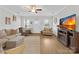Comfortable living room with a plush sofa, armchairs, hardwood floors, and a large screen TV, perfect for relaxation at 5405 Austin Rd, Monroe, NC 28112