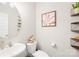 Stylish powder room with modern fixtures, decorative art, floating shelves, and ample counter space at 5405 Austin Rd, Monroe, NC 28112