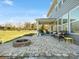 Spacious backyard patio featuring a fire pit, comfortable seating, and a view of the expansive lawn at 5585 Zeeland Ln, Fort Mill, SC 29707