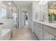 Stylish bathroom boasts a glass shower, a white double vanity, and a walk-in closet at 5585 Zeeland Ln, Fort Mill, SC 29707