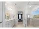 Bright bathroom features a double vanity and glass shower with views into the main bedroom at 5585 Zeeland Ln, Fort Mill, SC 29707