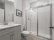 Modern bathroom with a glass-enclosed shower, white cabinets, and clean finishes at 5585 Zeeland Ln, Fort Mill, SC 29707