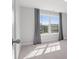 Light-filled bedroom featuring plush carpeting and a large window with neighborhood views at 5585 Zeeland Ln, Fort Mill, SC 29707