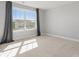 Bright bedroom featuring plush carpet and a large window with neighborhood views at 5585 Zeeland Ln, Fort Mill, SC 29707
