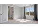 Sunlit bedroom with an ensuite bathroom featuring plush carpet and a large window at 5585 Zeeland Ln, Fort Mill, SC 29707