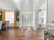 Bright foyer with hardwood floors, a decorative door, and views into the dining room at 5585 Zeeland Ln, Fort Mill, SC 29707