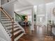 Spacious foyer with hardwood floors, modern chandelier, and views into dining room at 5585 Zeeland Ln, Fort Mill, SC 29707