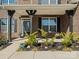 Inviting front porch with brick columns, black accents, a seating area, and landscaping at 5585 Zeeland Ln, Fort Mill, SC 29707