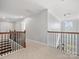 Hallway with wood and black iron railing offering multiple access points to rooms at 5585 Zeeland Ln, Fort Mill, SC 29707
