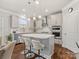 Charming eat-in kitchen boasts white cabinets, stainless appliances, and a center island at 5585 Zeeland Ln, Fort Mill, SC 29707