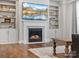 Living room features a fireplace with built-in shelving, decor, a TV, and hardwood floors at 5585 Zeeland Ln, Fort Mill, SC 29707