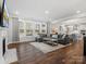 Bright living room features a large sectional couch, fireplace, and large windows at 5585 Zeeland Ln, Fort Mill, SC 29707