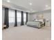 Spacious main bedroom with neutral carpet, tray ceiling, and light-filled windows with curtains at 5585 Zeeland Ln, Fort Mill, SC 29707