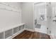 Mudroom features white cubbies with hooks and a laundry room with gray machines is visible through the doorway at 5585 Zeeland Ln, Fort Mill, SC 29707