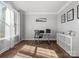 Well-lit home office with hardwood floors, large windows, and minimalist decor at 5585 Zeeland Ln, Fort Mill, SC 29707