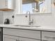 Close-up of kitchen sink with stainless faucet and modern backsplash at 5585 Zeeland Ln, Fort Mill, SC 29707