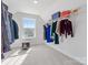 Bright walk-in closet featuring ample shelving and a window for natural light at 5585 Zeeland Ln, Fort Mill, SC 29707