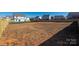 Wide backyard view of a large backyard features with grass and new seeding, all fenced in at 6015 Ahoskie Dr, Charlotte, NC 28215