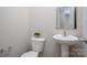 Charming powder room features a pedestal sink and toilet, offering a functional space at 6015 Ahoskie Dr, Charlotte, NC 28215