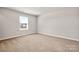 Neutral bedroom with wall to wall carpet and a window at 6015 Ahoskie Dr, Charlotte, NC 28215