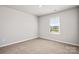 Neutral bedroom with wall to wall carpet and a window at 6015 Ahoskie Dr, Charlotte, NC 28215