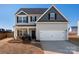 Charming two-story home with gray siding, black shutters, and a two-car garage at 6015 Ahoskie Dr, Charlotte, NC 28215