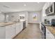 Bright kitchen with stainless steel appliances, granite countertops, and an adjacent dining area at 6015 Ahoskie Dr, Charlotte, NC 28215