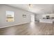 Open-concept living area with wood flooring, sliding door, and kitchen in view at 6015 Ahoskie Dr, Charlotte, NC 28215