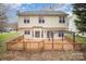 View of the home's back exterior showcasing a large deck and well-kept yard at 6027 Edinmeadow Ln # 29, Charlotte, NC 28269
