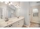 Bright bathroom features double sink vanity, large mirror, and separate tub and shower at 6027 Edinmeadow Ln # 29, Charlotte, NC 28269
