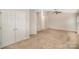 Spacious bedroom with neutral carpet, ceiling fan, and a double door closet at 6027 Edinmeadow Ln # 29, Charlotte, NC 28269