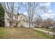 Two-story home with landscaped yard, driveway, and mature trees on a sunny day at 6027 Edinmeadow Ln # 29, Charlotte, NC 28269