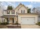 Two-story home with vinyl siding, black shutters, attached garage, and manicured landscaping at 6027 Edinmeadow Ln # 29, Charlotte, NC 28269