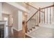 Open foyer with hardwood floors, wooden staircase with iron railings, and natural light at 6027 Edinmeadow Ln # 29, Charlotte, NC 28269