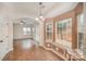 Eat-in kitchen view towards spacious living room with an arched entryway and outdoor views at 6027 Edinmeadow Ln # 29, Charlotte, NC 28269