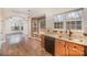 Open concept kitchen with wood cabinetry, granite counters, modern appliances, and views to the living room at 6027 Edinmeadow Ln # 29, Charlotte, NC 28269