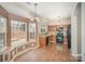 Eat-in kitchen boasts wood cabinets, granite countertops, black appliances, and natural light from outdoor views at 6027 Edinmeadow Ln # 29, Charlotte, NC 28269