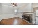 Living room featuring hardwood floors, fireplace with stone surround, and natural light at 6027 Edinmeadow Ln # 29, Charlotte, NC 28269