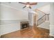 Living room featuring hardwood floors, fireplace with stone surround, and staircase at 6027 Edinmeadow Ln # 29, Charlotte, NC 28269