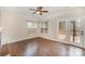 Bright living room with hardwood floors, ceiling fan, and views to the outdoor patio at 6027 Edinmeadow Ln # 29, Charlotte, NC 28269