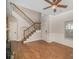 Living room with hardwood floors, white trim, staircase, and natural light from window at 6027 Edinmeadow Ln # 29, Charlotte, NC 28269