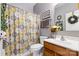 Well-lit bathroom with a shower/tub combo and decor at 7003 Dacian Ln, Indian Trail, NC 28079