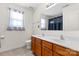 Bright bathroom features double sink vanity with tile flooring and a large mirror at 7003 Dacian Ln, Indian Trail, NC 28079