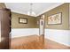 Formal dining room with hardwood floors, wainscoting, and neutral paint at 7003 Dacian Ln, Indian Trail, NC 28079